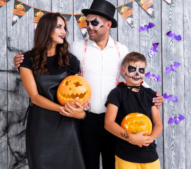 Family with carved pumpkins for halloween