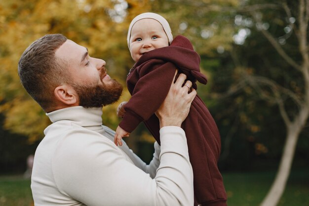 Family with cute daughter. Father in a bbrown sweater. Little girl with a dad.