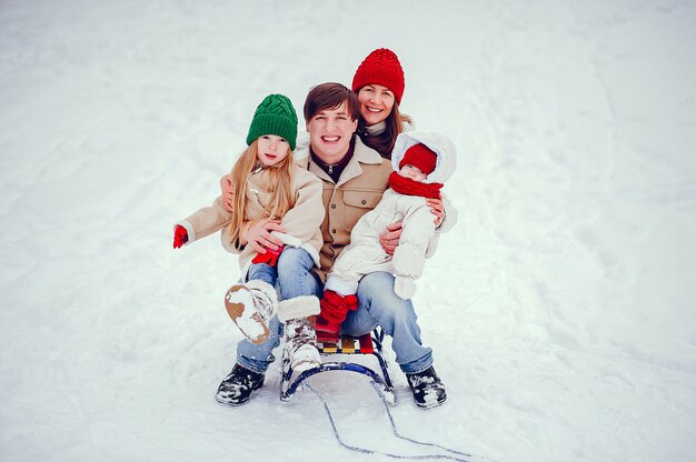 Family with cute daughters in a winter park