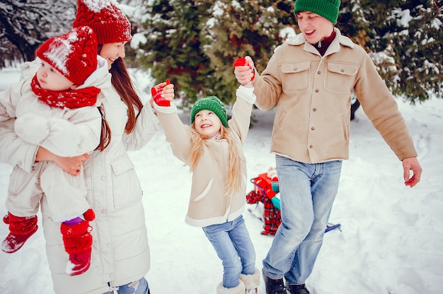 Family with cute daughters in a winter park