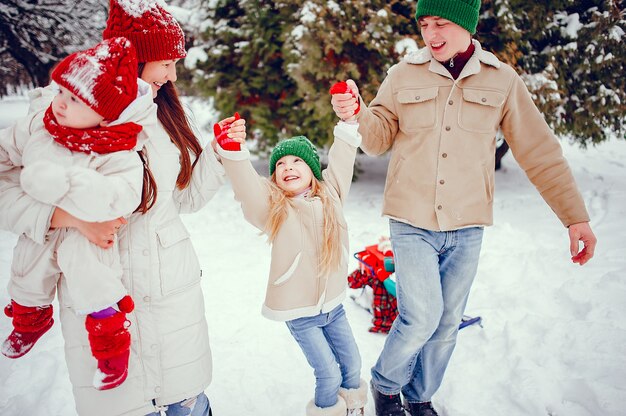 Family with cute daughters in a winter park