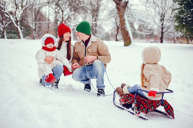 Family with cute daughters in a winter park