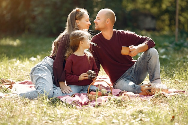 Free photo family with cute kids in a autumn park