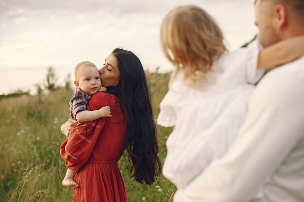 Family with cute little child. Father in a white shirt. 