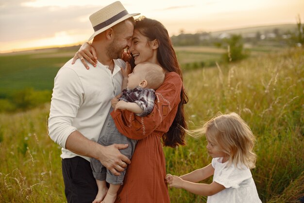 Family with cute little child. Father in a white shirt. 