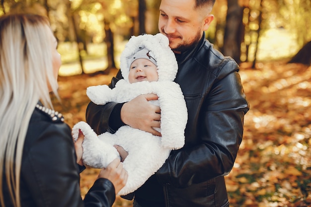 Family with daughter in a autumn park