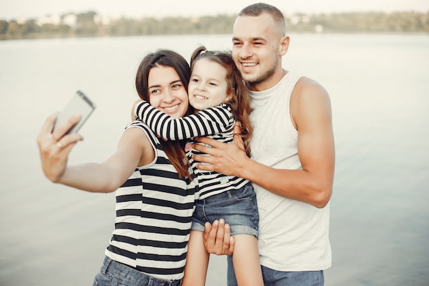 Family with daughter playing on a sand