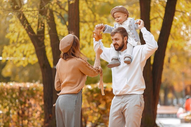 Family with little daughter in a autumn park