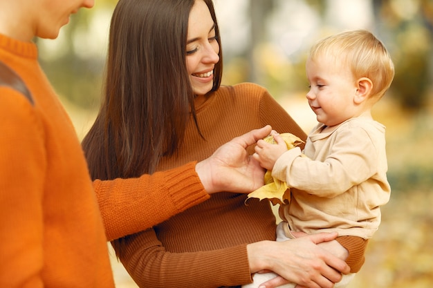 Family with little daughter in a autumn park