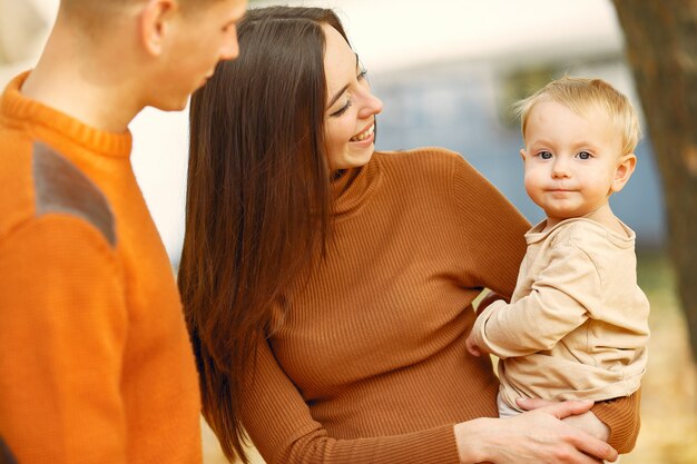 Family with little daughter in a autumn park