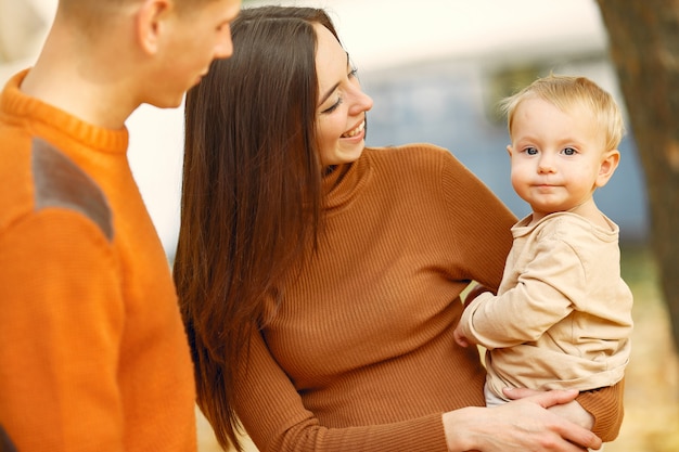 Family with little daughter in a autumn park