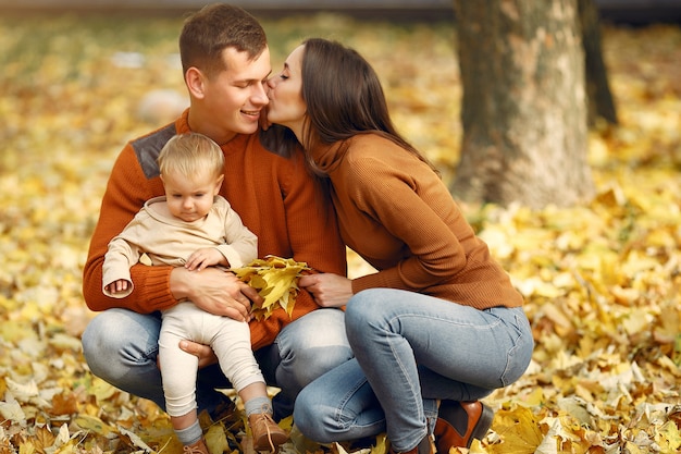 Family with little daughter in a autumn park