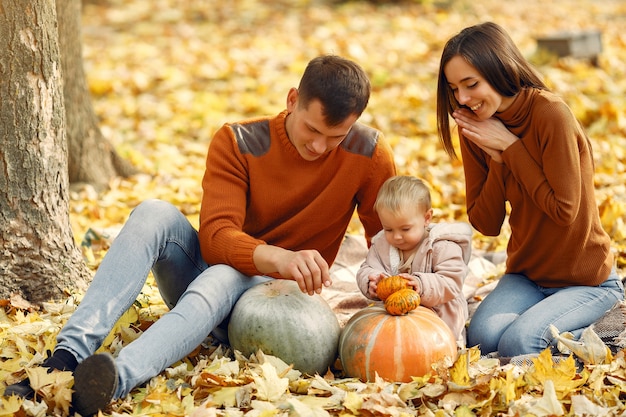 Family with little daughter in a autumn park