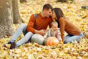 Free photo family with little daughter in a autumn park