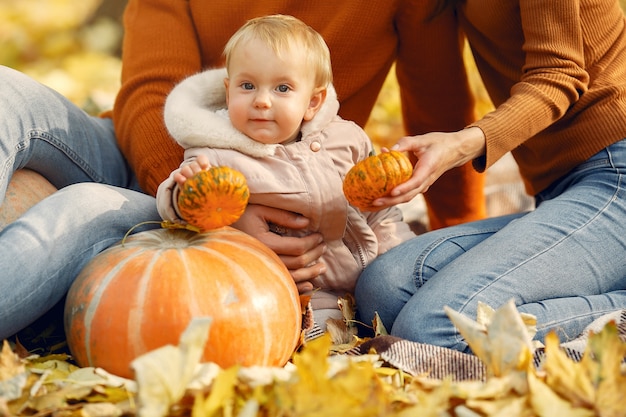 Family with little daughter in a autumn park