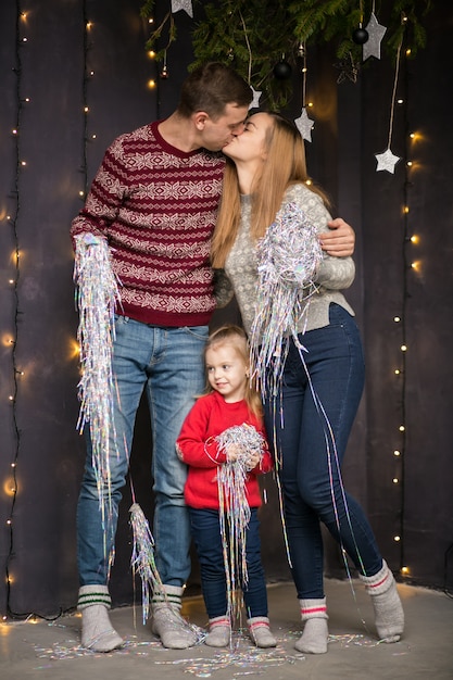 Family with little daughter celebrating New Year