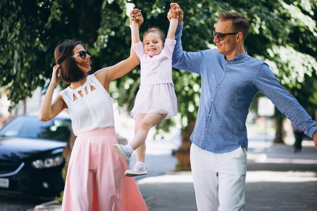 Family with little daughter together in park