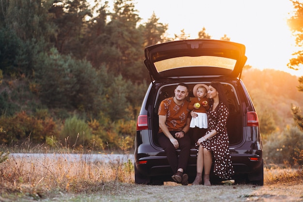 Family with little daughter travelling by car