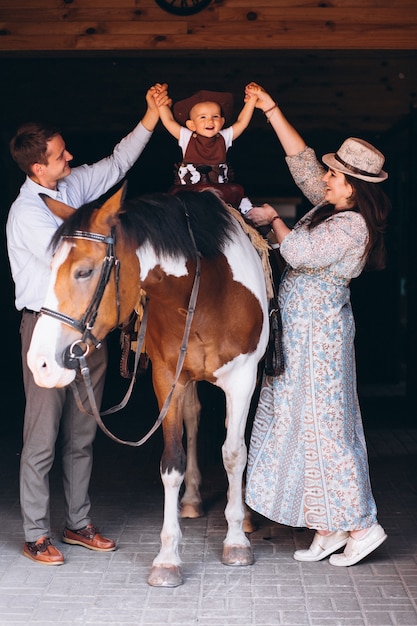 Family with little son at ranch