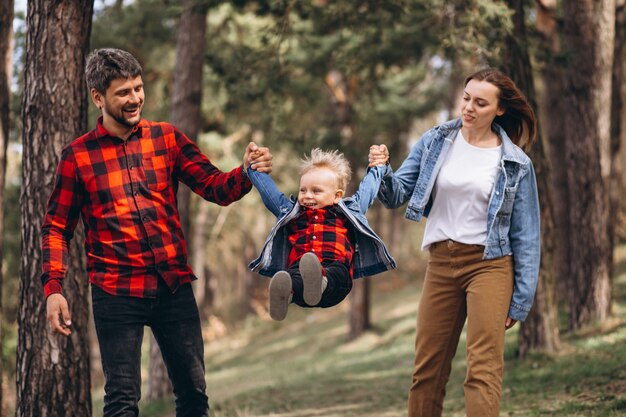 Family with little son together in the forest