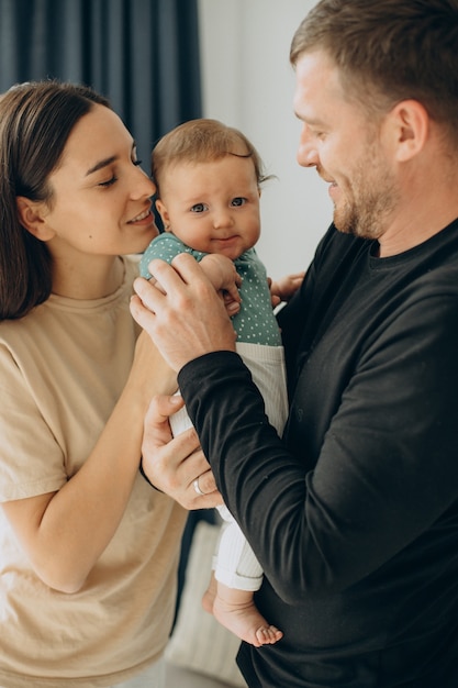 Family with their baby daughter at home