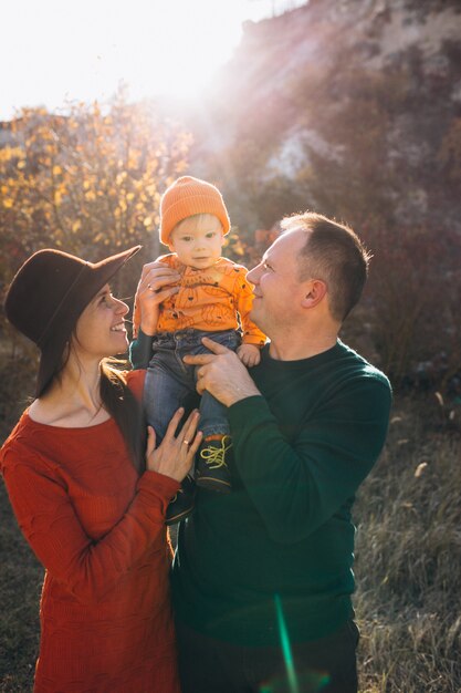 Family with their little son in an autumn park