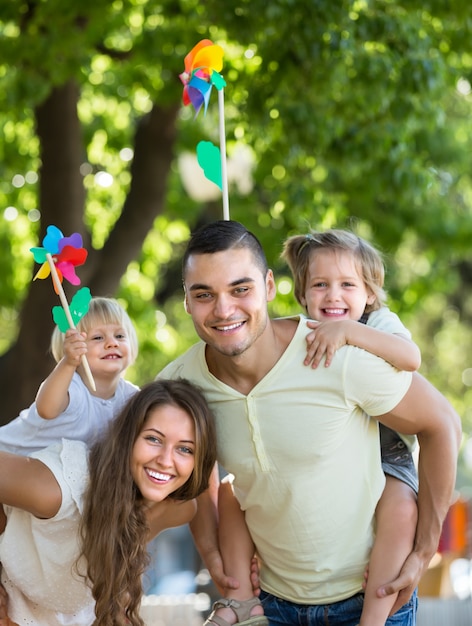 Family with toy windmills at park