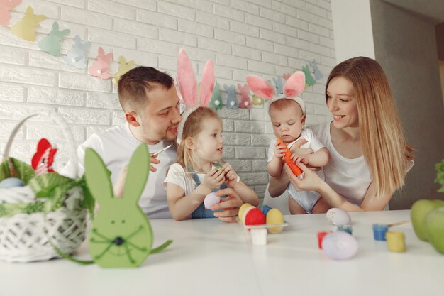 Family with two kids in a kitchen preparing to easter