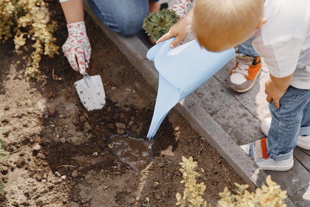 Family works in a garden near the house