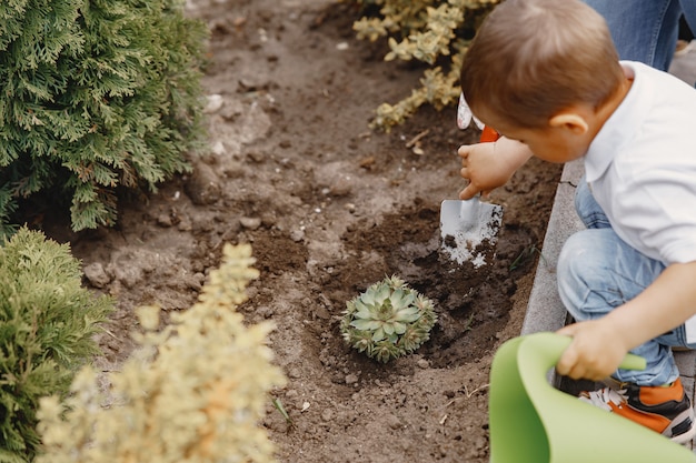 Family works in a garden near the house