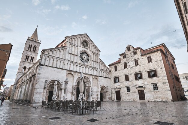 Знаменитая церковь Святого Доната Задар в Хорватии с небольшим кафе ранним утром.