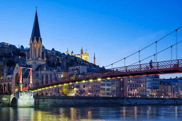 Famous view of church in Lyon with Saone river at night