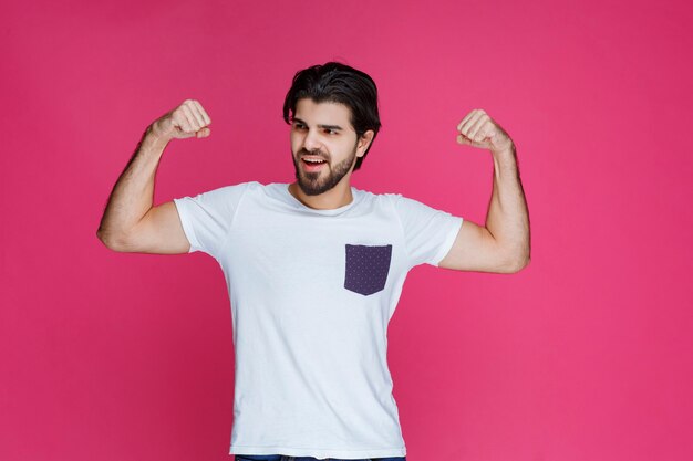 A fan showing his fist and muscles as his team won. 