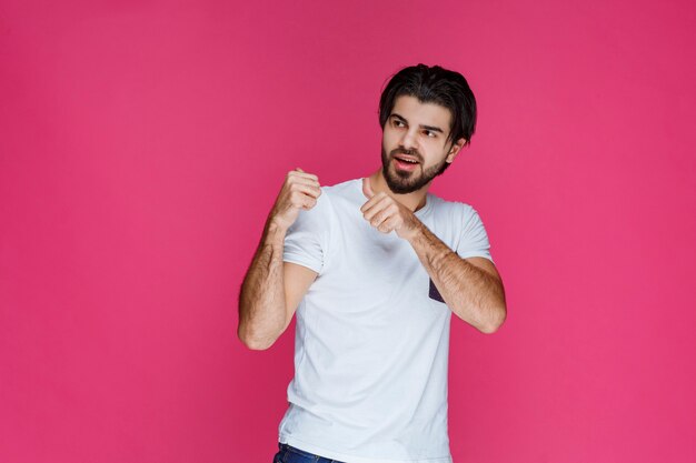 A fan showing his fist and muscles as his team won. 