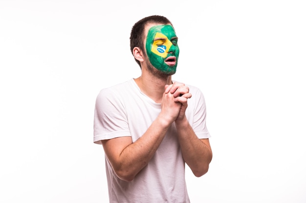 Fan support of Brazil national team pray with painted face isolated on white background