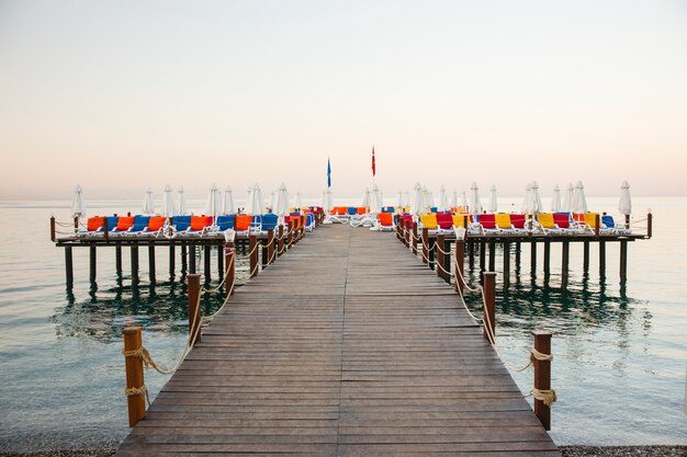 Fantastic colorful deckchairs on wooden walkway