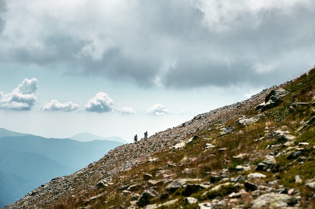 Fantastic shot of hikers in the distance climbing a slope of a mountain in the French Riviera