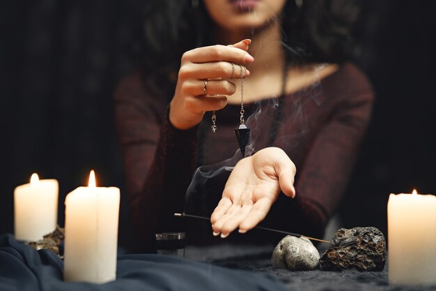 Fantasy beautiful gypsy girl. Fortune teller woman reading future on magical tarot cards.