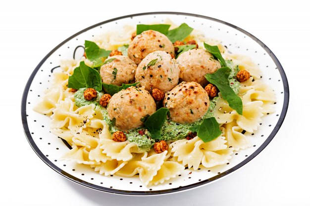 Farfalle pasta with meatballs and spinach sauce with fried chickpeas.