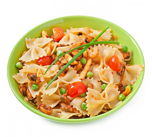 Farfalle pasta with seafood, cherry tomatoes and green peas