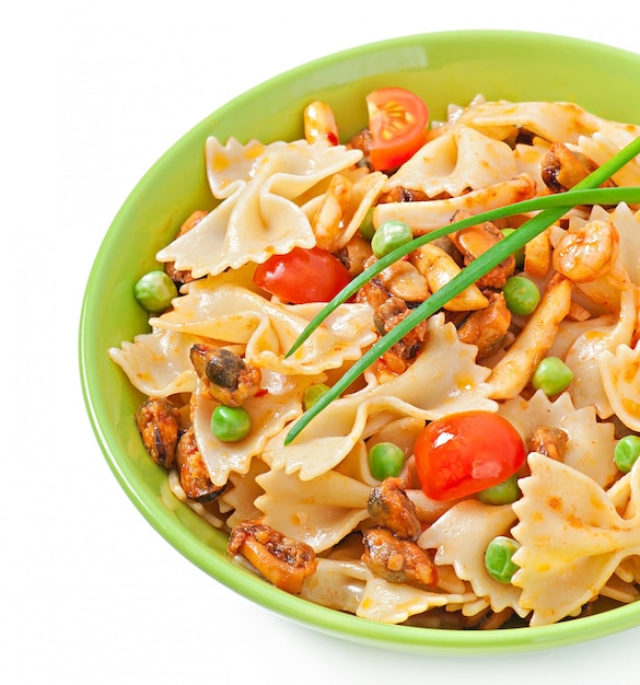 Farfalle pasta with seafood, cherry tomatoes and green peas