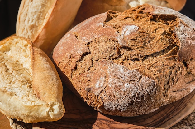 Farm bakery products artisan rye and wheat bread traditional pastries in Turkey Natural lighting fresh bread on the table closeup selective focus Homemade bread with whole wheat flour