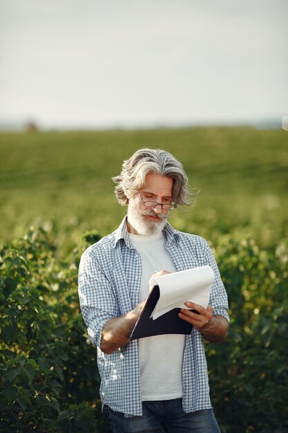 Farmer examines the field. Agronomist or farmer examines the growth of wheat.