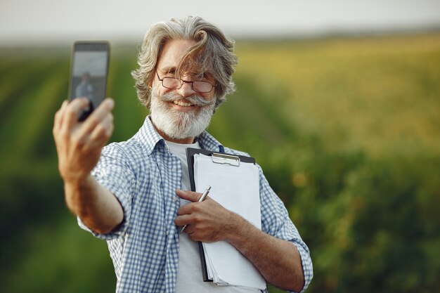 Farmer examines the field. Agronomist or farmer examines the growth of wheat.