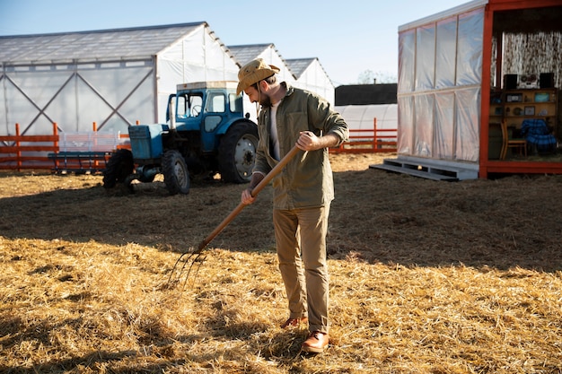 Farmer raking hay at the farm