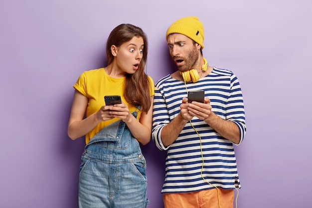 Fascinated surprised woman and man ignore real communication,\
scared of bad internet connection, cannot find answer on exam