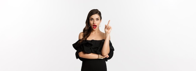 fashion-beauty-attractive-caucasian-woman-black-dress-having-idea-raising-finger-sayin_1258-172437.jpg