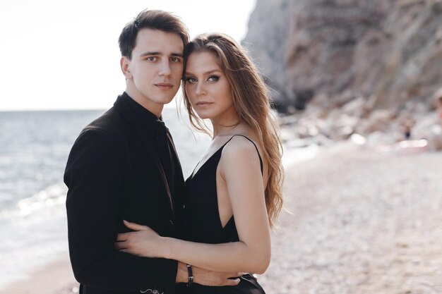 fashion couple in black dress and suit outdoor