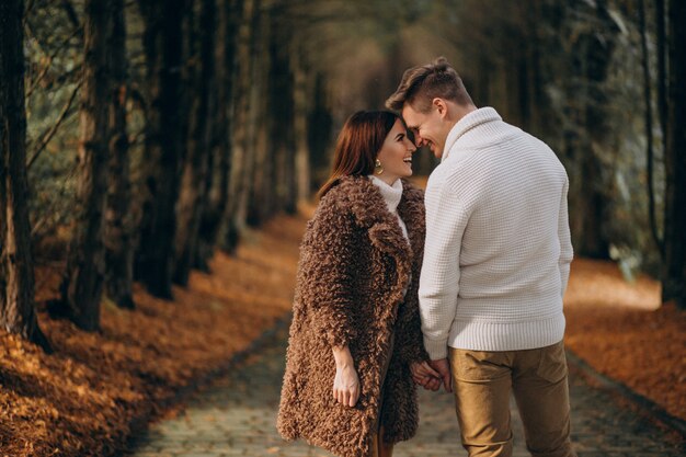 Fashion couple together walking in the park