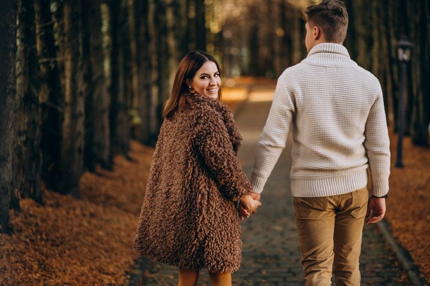 Fashion couple together walking in the park